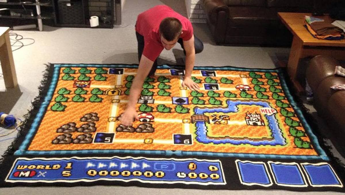 The finished Mario blanket laid out on the floor